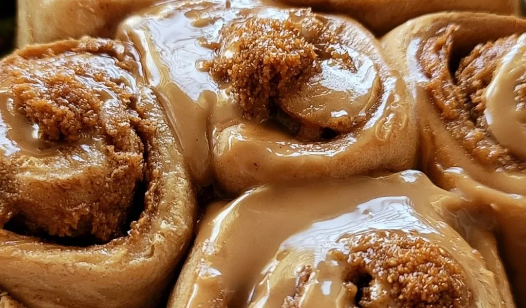 Soft Biscoff cinnamon rolls topped with cookie butter glaze