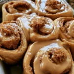 Soft Biscoff cinnamon rolls topped with cookie butter glaze