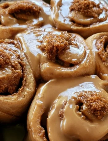 Soft Biscoff cinnamon rolls topped with cookie butter glaze