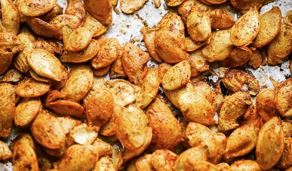 Deliciously roasted pumpkin seeds in a bowl, ready to enjoy as a healthy snack.