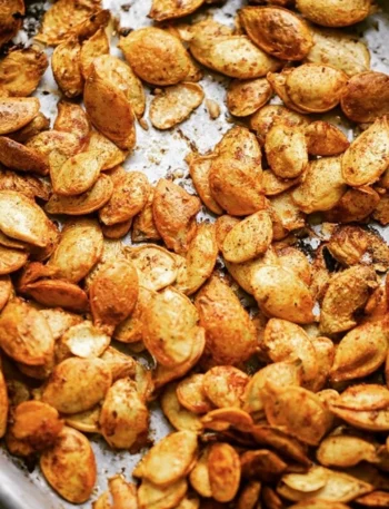 Deliciously roasted pumpkin seeds in a bowl, ready to enjoy as a healthy snack.