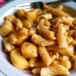 A plate of pasta served with creamy potato sauce and garnished with herbs.