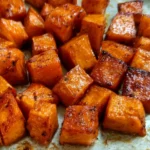 Plate of roasted sweet potatoes seasoned and garnished