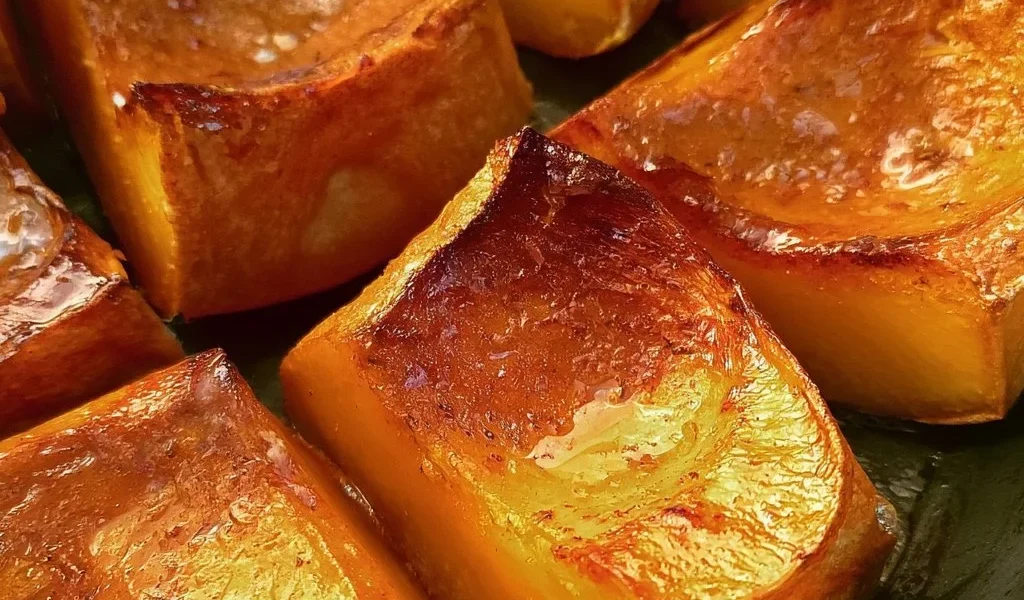 Delicious and sweet roasted pumpkin slices garnished with herbs