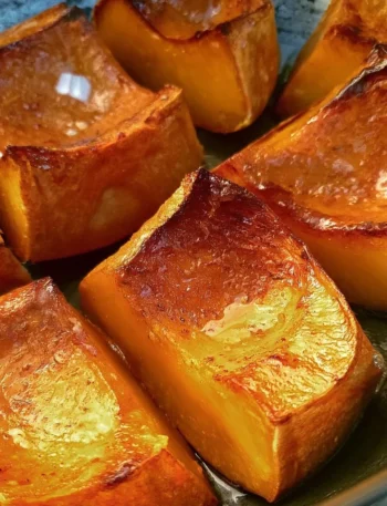 Delicious and sweet roasted pumpkin slices garnished with herbs