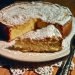 A beautifully sliced piece of Grandmother's Cake with fresh icing and berries.
