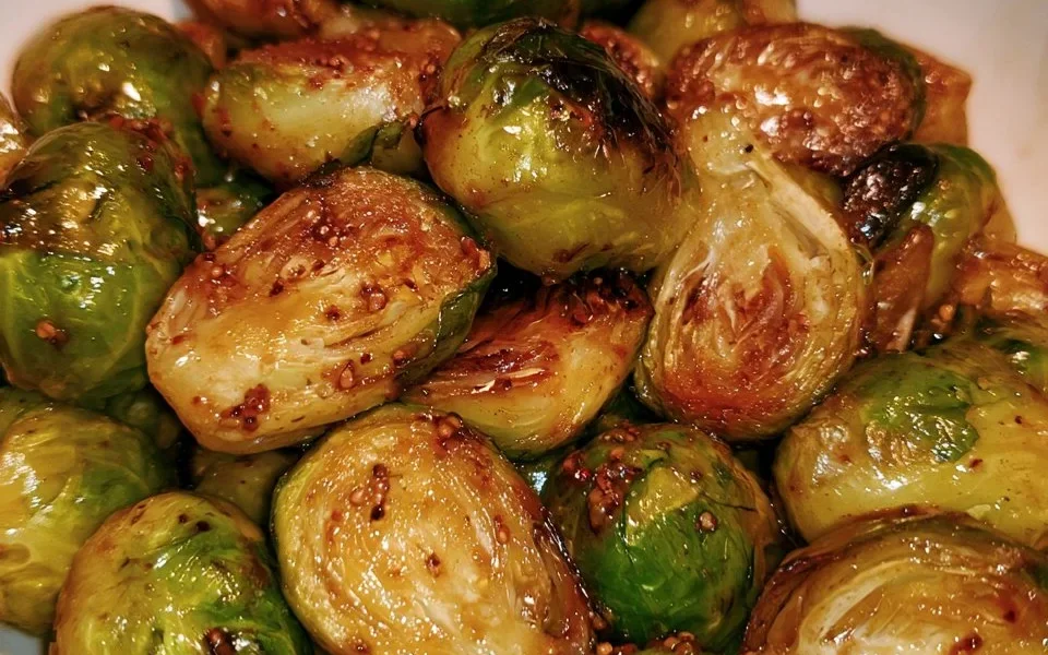 Cavolini di Bruxelles arrosto con miele e senape serviti in un piatto