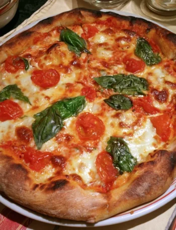 Pizza Margherita fatta in casa con pomodoro, mozzarella e basilico fresco
